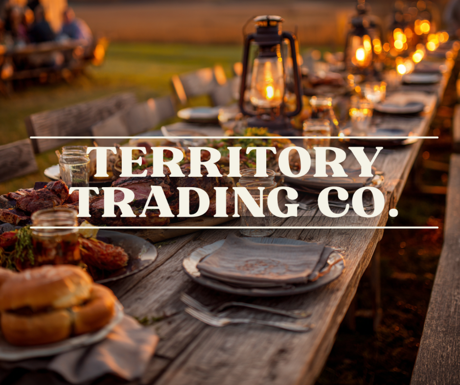 Outdoor dinner setting with 'Territory Trading Co.' text overlay